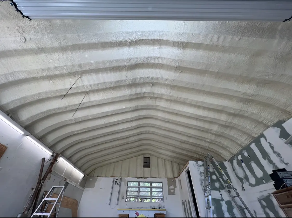 Spray polyurethane foam applied to the underside of a metal roof deck in Colesville